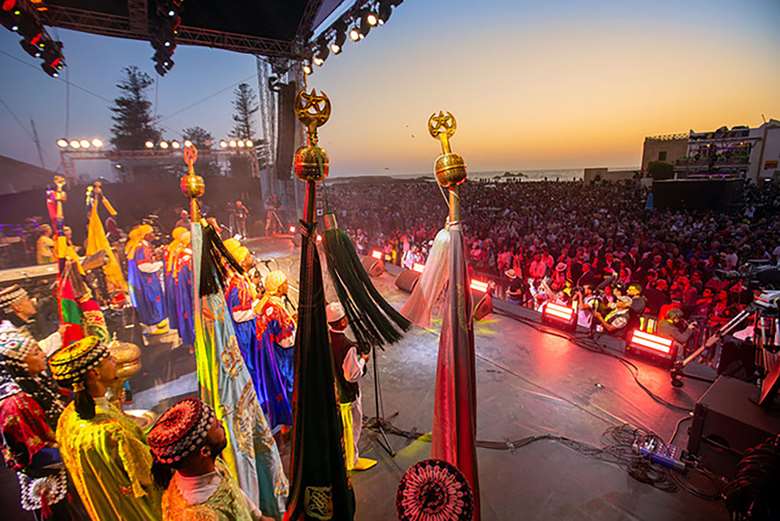 Maalem Mohamed Kouyou in a fusion with the Drummers of Burundi at Gnaoua 2023 – Photo by Zak