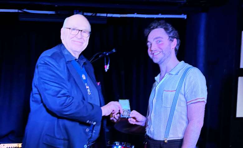 Nico Widdowson (right) receives his award from Master of the Musicians' Company, Richard Lyttelton